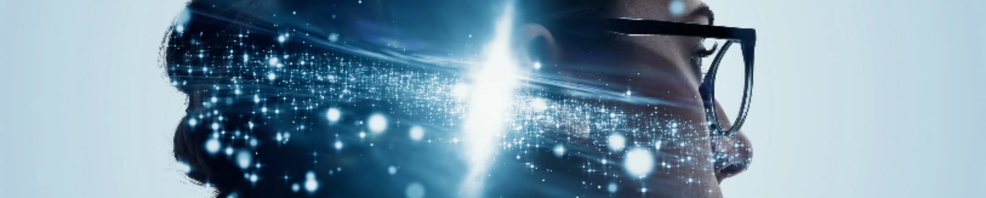Profile of a person wearing glasses with glowing light particles