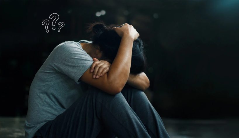 Person sitting alone looking sad